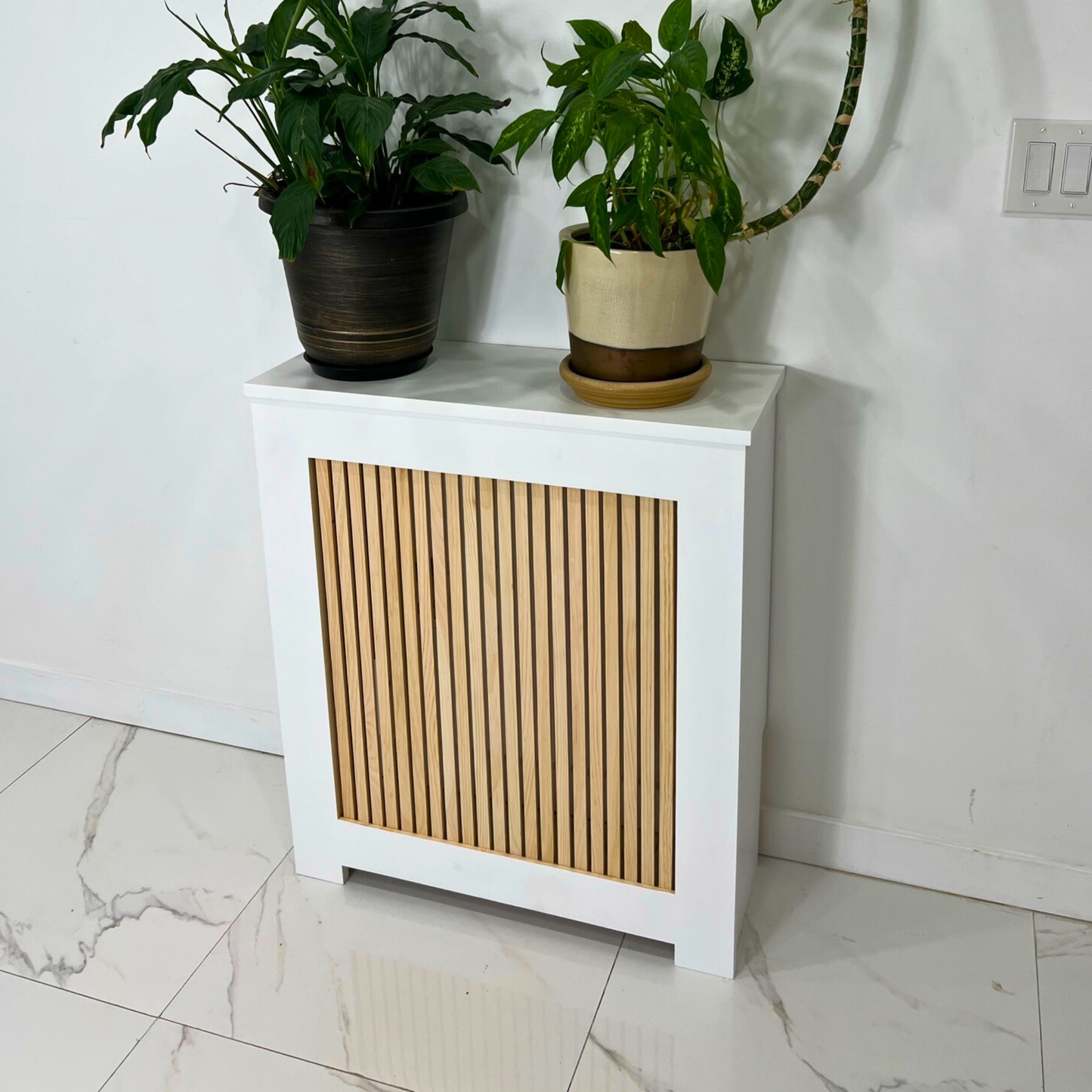 What are the benefits of using radiator covers in home decor? How can radiator covers enhance heating efficiency? What materials are commonly used in radiator cover construction? Are there customizable options for radiator covers? Can radiator covers be painted or stained to match room decor? Are radiator covers easy to install and maintain? Are there safety considerations when using radiator covers?