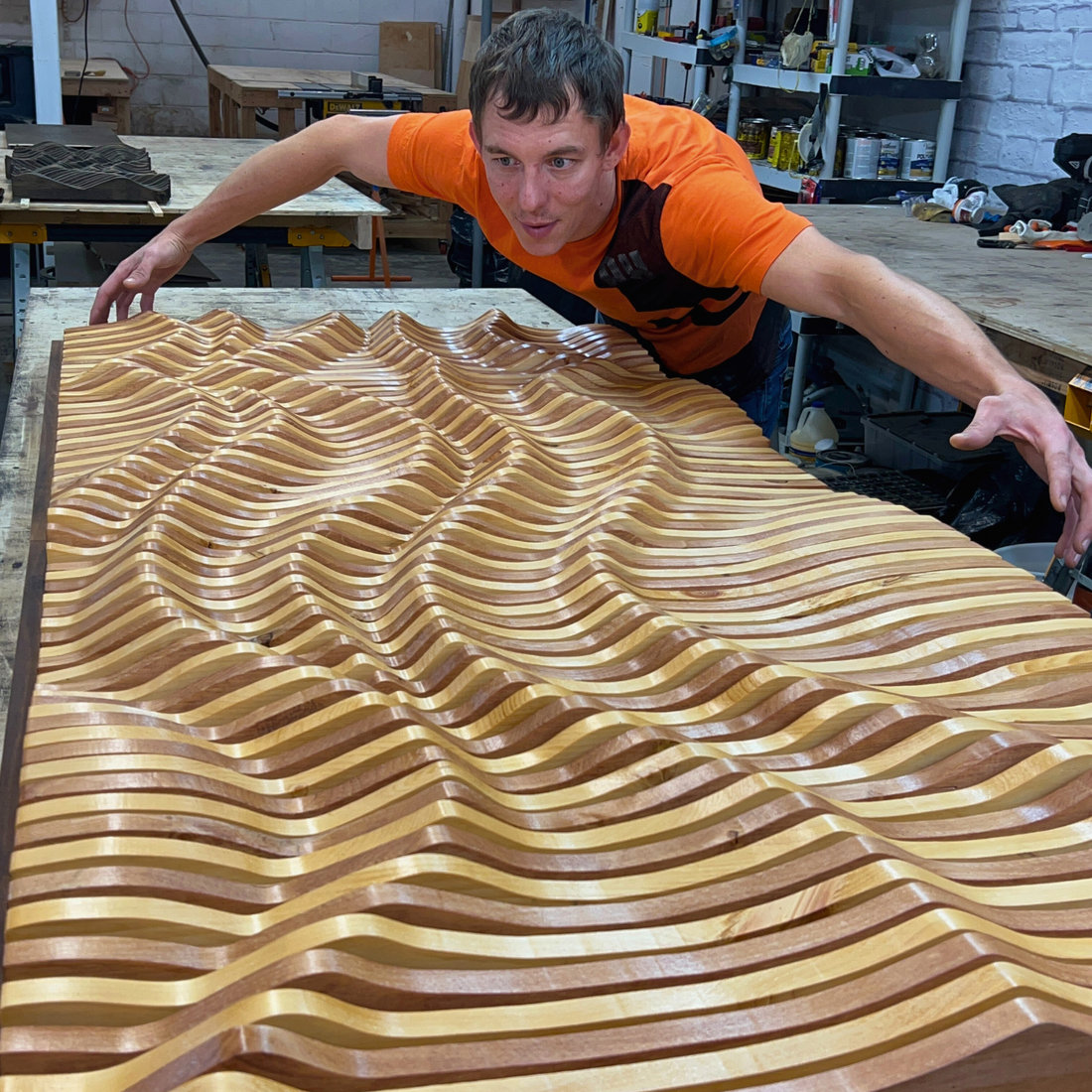 Craftsman installing elegant 3D wooden architectural wall panel design