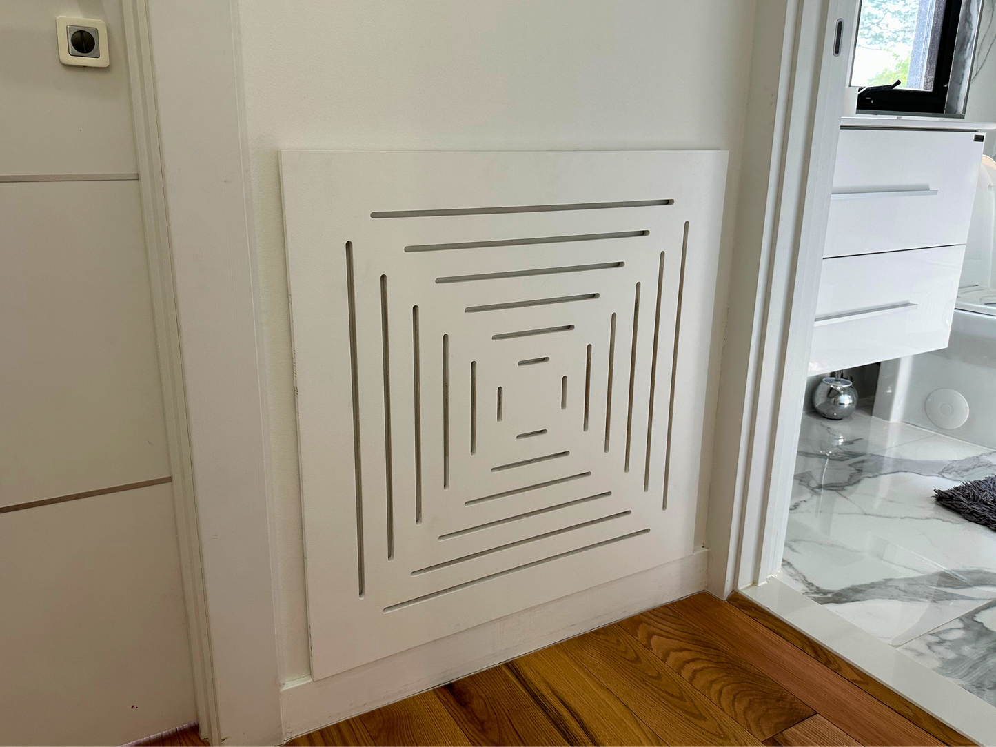 Close-up detail of smooth white Medex wood surface on magnetic vent cover