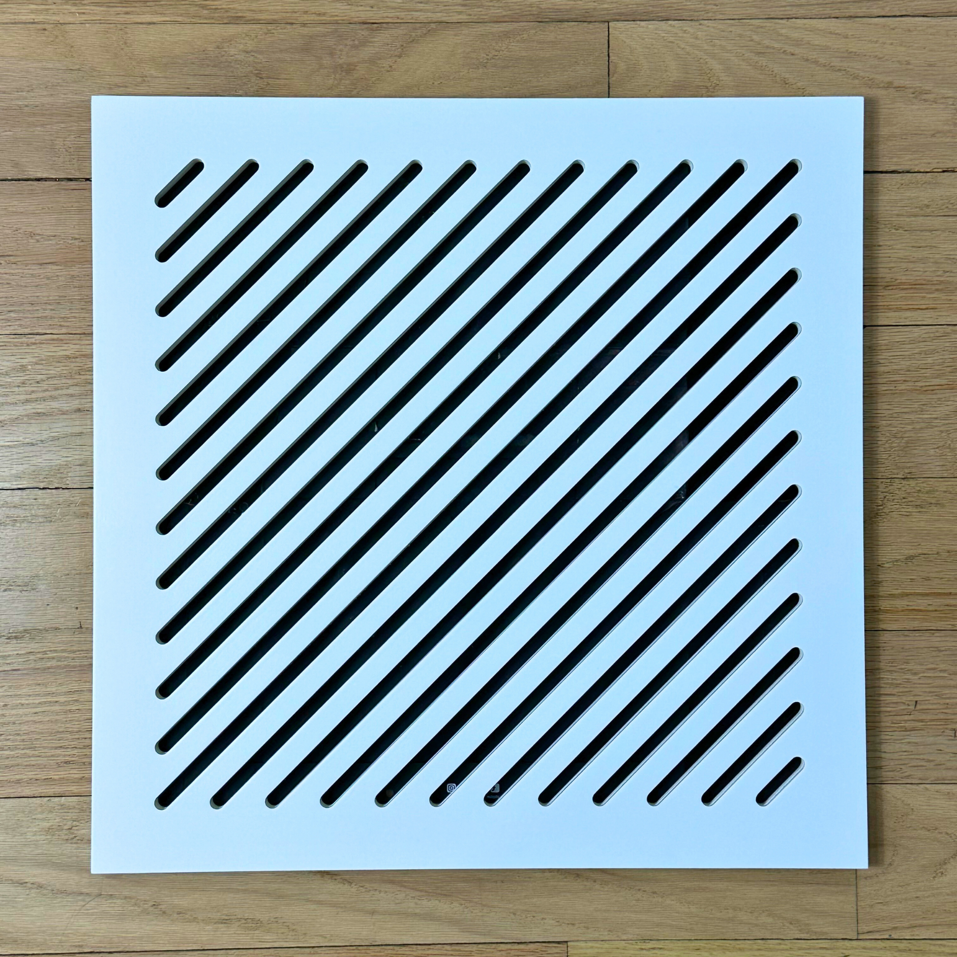 Close-up detail of smooth white Medex wood surface on magnetic vent cover