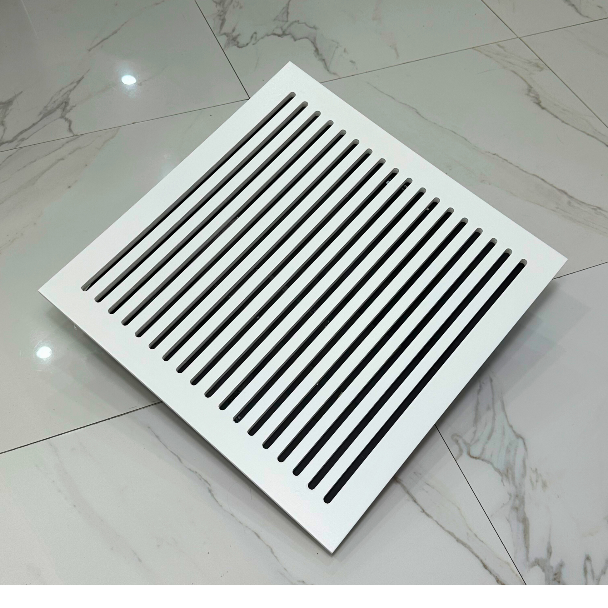 Large white magnetic air vent cover placed over HVAC opening with tool-free installation