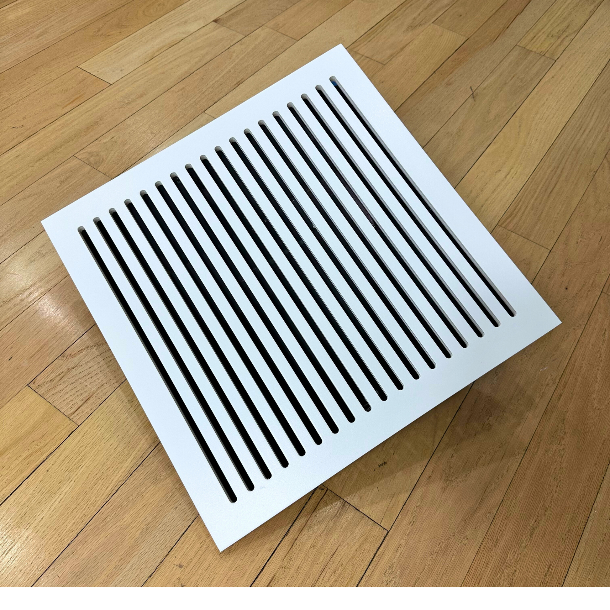 Modern white magnetic HVAC vent cover installed on wall in contemporary interior