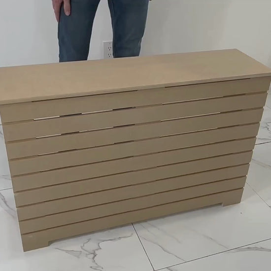 Slatted-style unfinished radiator cover in MDF, displayed in modern tiled room, ideal for DIY painting and NYC apartments.