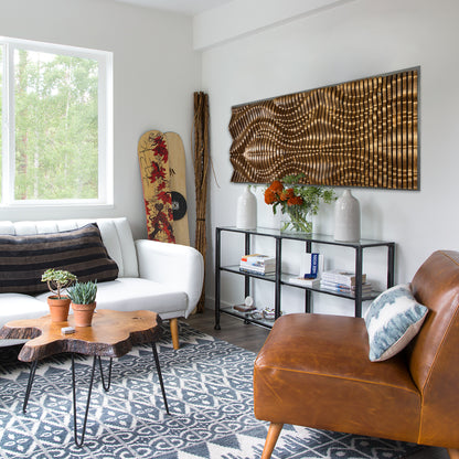 GOLIATHUS Acoustic Wall Art Panel in solid wood mounted in a bright modern living room with eclectic decor and natural light.
